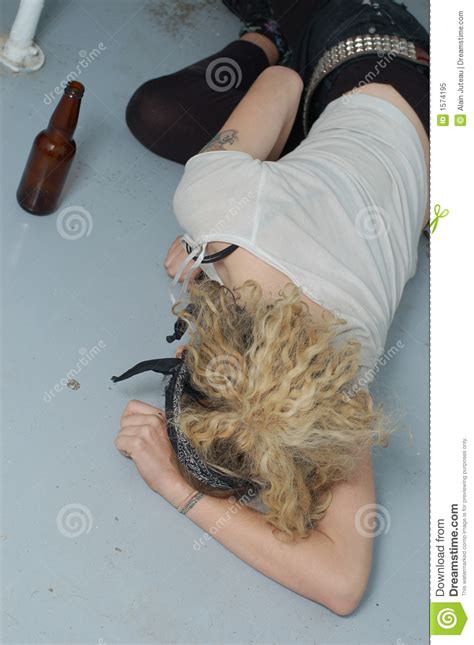 drunk girl on the floor focus on head and left hand stock