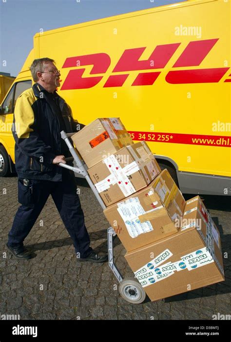 dpa  employee  dhl worldwide express pushes parcels   delivery stock  duesseldorf