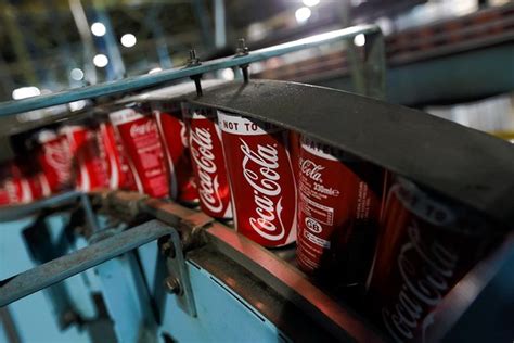 coke promises cost cuts as profit falls wsj