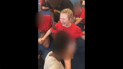 cheerleading coach fired after being caught on video forcing teens into