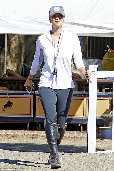 make up free kaley cuoco highlights her toned curves in white blouse and tight jodhpurs as she
