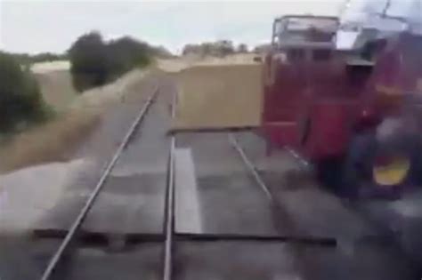 Watch Incredibly Close Miss Between Tractor And Train At Level Crossing