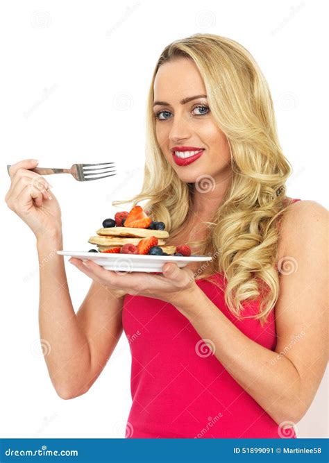 young woman eating pancakes witrh fruit  syrup stock image image  food background