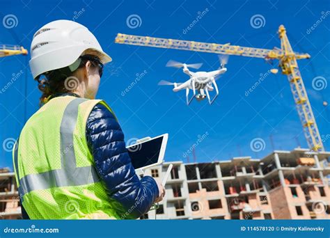 drone inspection operator inspecting construction building site flying  drone stock photo