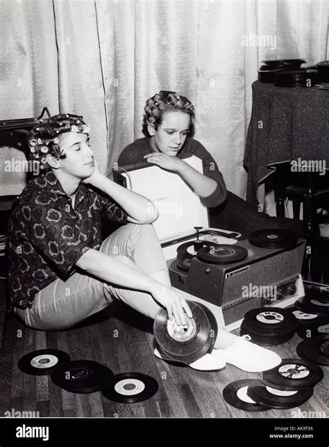 Two Teenage Girls In Curlers Dreamily Listening To 45 Rpm
