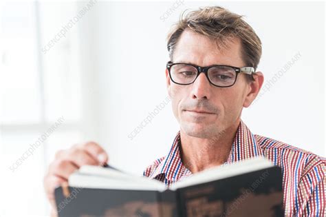 man wearing glasses reading a book stock image c034 1995 science