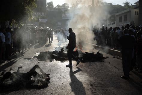 haitian residents lynch  set fire  suspected gang members