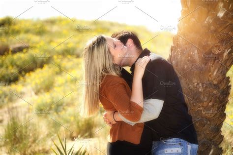 lovers kissing under a palm tree high quality people images