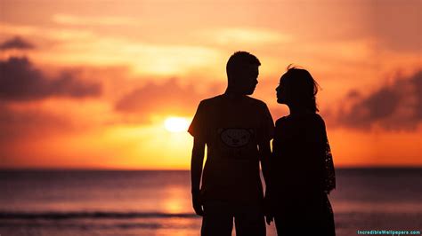 asian couple on beach during sunset couple on beach during sunset