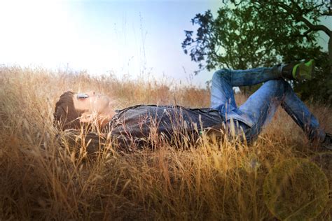 boy laying    sun     grass image  stock