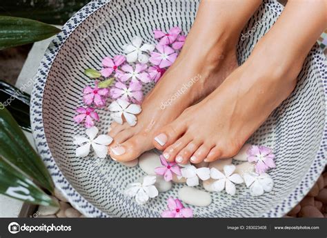 spa treatment product woman feet foot spa foot bath bowl stock photo