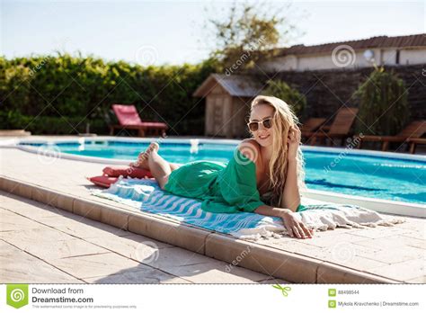 Beautiful Blonde Girl In Sunglasses Sunbathing Lying Near