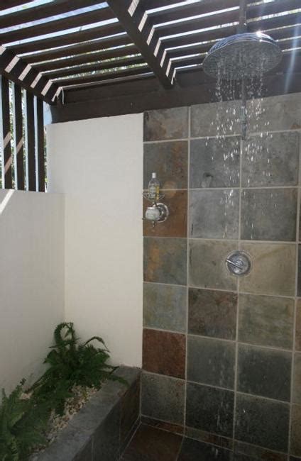 outdoor shower design ideas showing beautiful tiled  stone walls