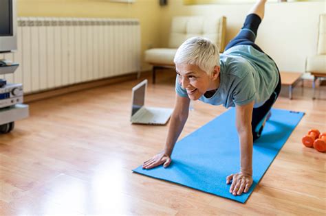 Fitness Determined Mature Woman Lying Doing Crunches At Home Healthy