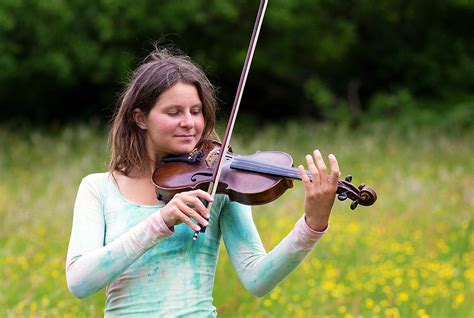 Violinist On A Meadow Full Of Flowers Young Girl Playing Music