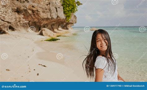 A Charming And Happy Philippine Teenage Girl In A White Summer Dress Is