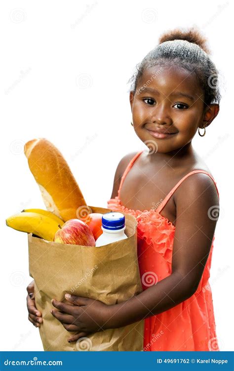cute african kid holding groceries  brown bag stock photo image
