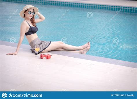 woman laying  swimming pool stock photo image  luxury orange