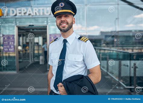 handsome male pilot standing   street stock image image