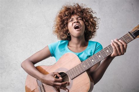 woman playing acoustic guitar  singing    uni