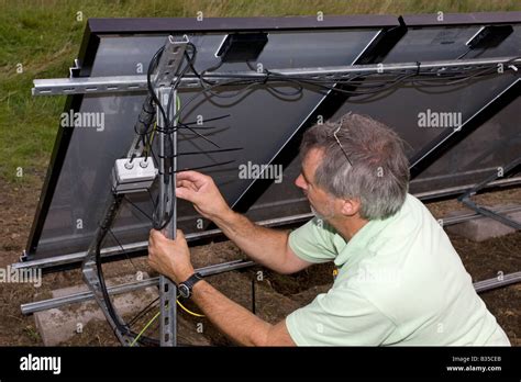 electrician installing wiring  array   solar hybrid pv panels stock photo royalty