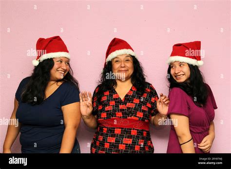 Body Positive Overweight Latina Mom And Daughters Wearing Santa Hats