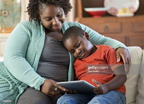 black mother and son using digital tablet together photo getty images