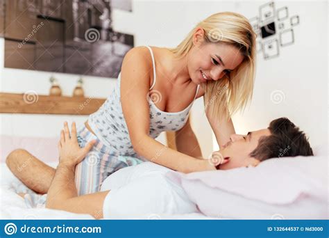 Tenderness Od A Beautiful Couple In Bedroom Stock Image