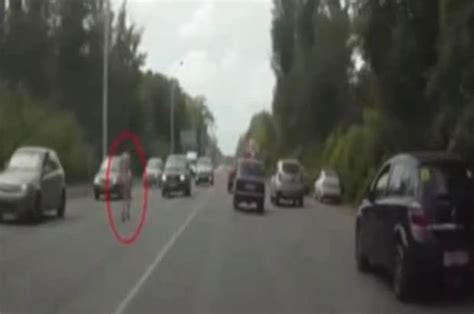 naked woman filmed running through traffic during roadside