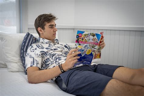 Man Reading In Bedroom 2 Surf Beach Holiday Park