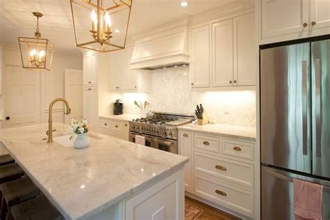 Custom white cabinets with antique brass fixtures and