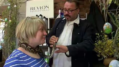four foot python is an employee at german hair salon where it gives neck massages