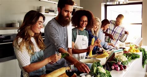 Group Of Multi Racial Friends Cooking Dinner In A Kitchen