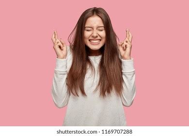pleased cheerful brunette woman puts  stock photo
