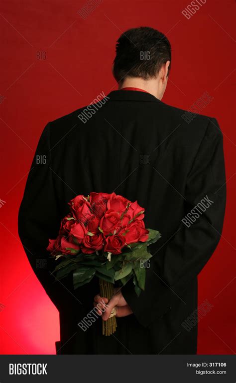 man holding roses behind his back image and photo bigstock