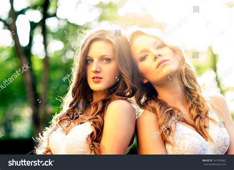 Two Beautiful Girls Outdoors Backlight Portrait Stock