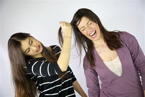 Girl Pulling Hard Long Hair Of Her Friend Stock Image