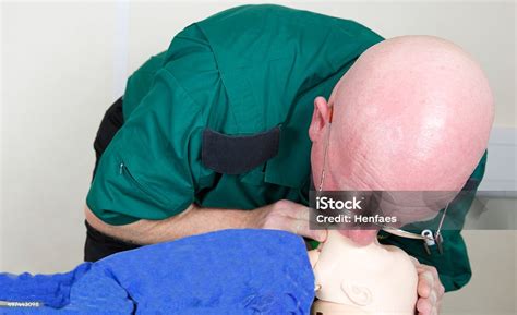 paramedic nurse attempting resuscitation mouth  mouthnose