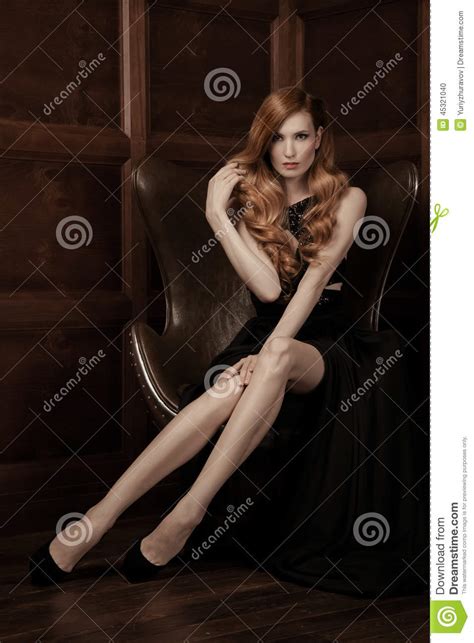 Beautiful Luxurious Woman Sitting On A Leather Vintage