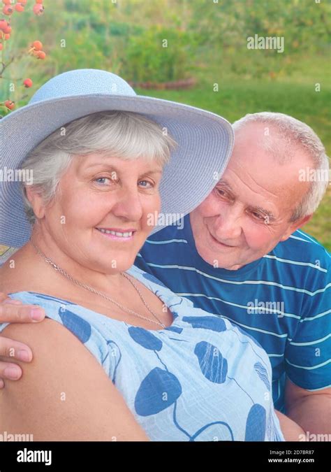 Authentic Outdoor Shot Of Aging Couple Having Fun In The Garden And