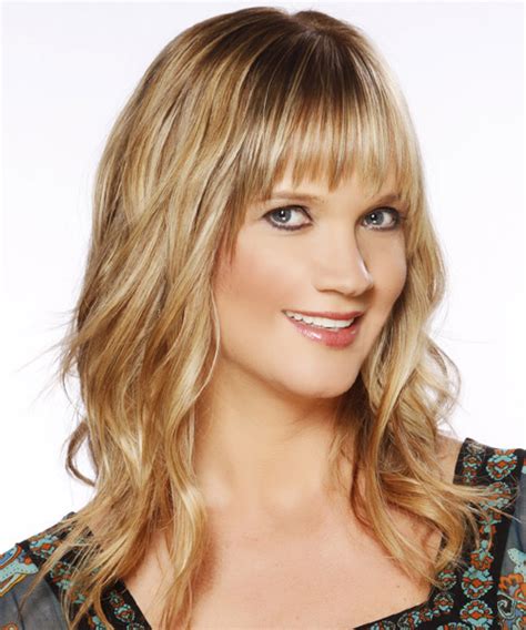 Long Wavy Golden Blonde Hairstyle With Layered Bangs And