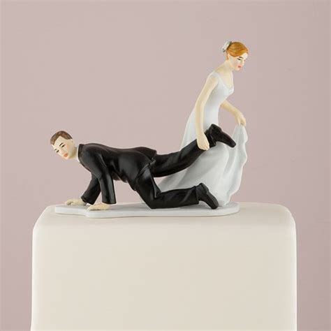 comical couple with the bride having the upper hand cake topper the