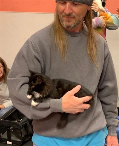 kitten walks up to man insists on being cuddled she wouldn t have it