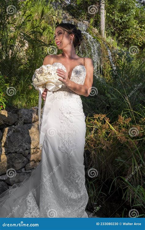 A Lovely Brunette Bride Poses In Her Wedding Dress Before Her Big Day