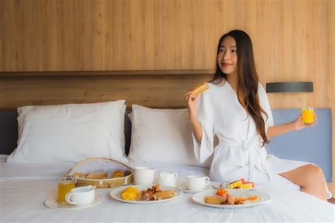 Free Photo Asian Woman Enjoying With Breakfast On Bed
