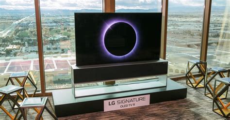 lg s roll up oled tv comes out of hiding only when tv time rolls around