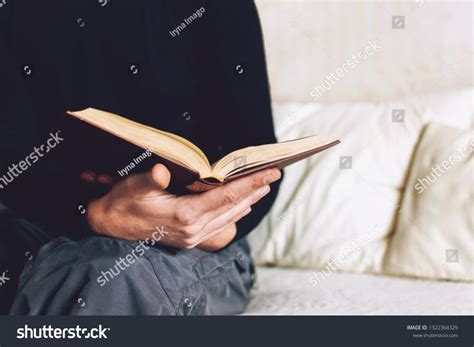 man holding open book  hands male hands hold  hardcover book