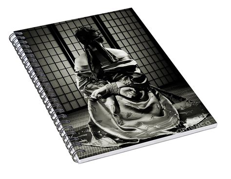 asian woman with her hands tied behind her back spiral notebook for
