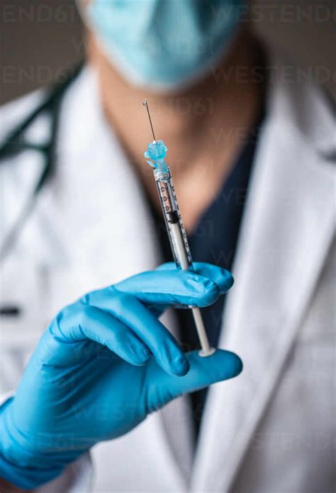 close   doctor holding needle  vaccine ready  inject stock photo
