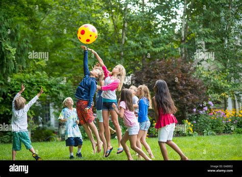 children playing ball game  garden stock photo  alamy